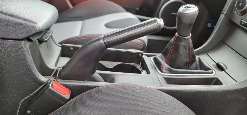 The land rover has a lever for the parking brake, another to shift