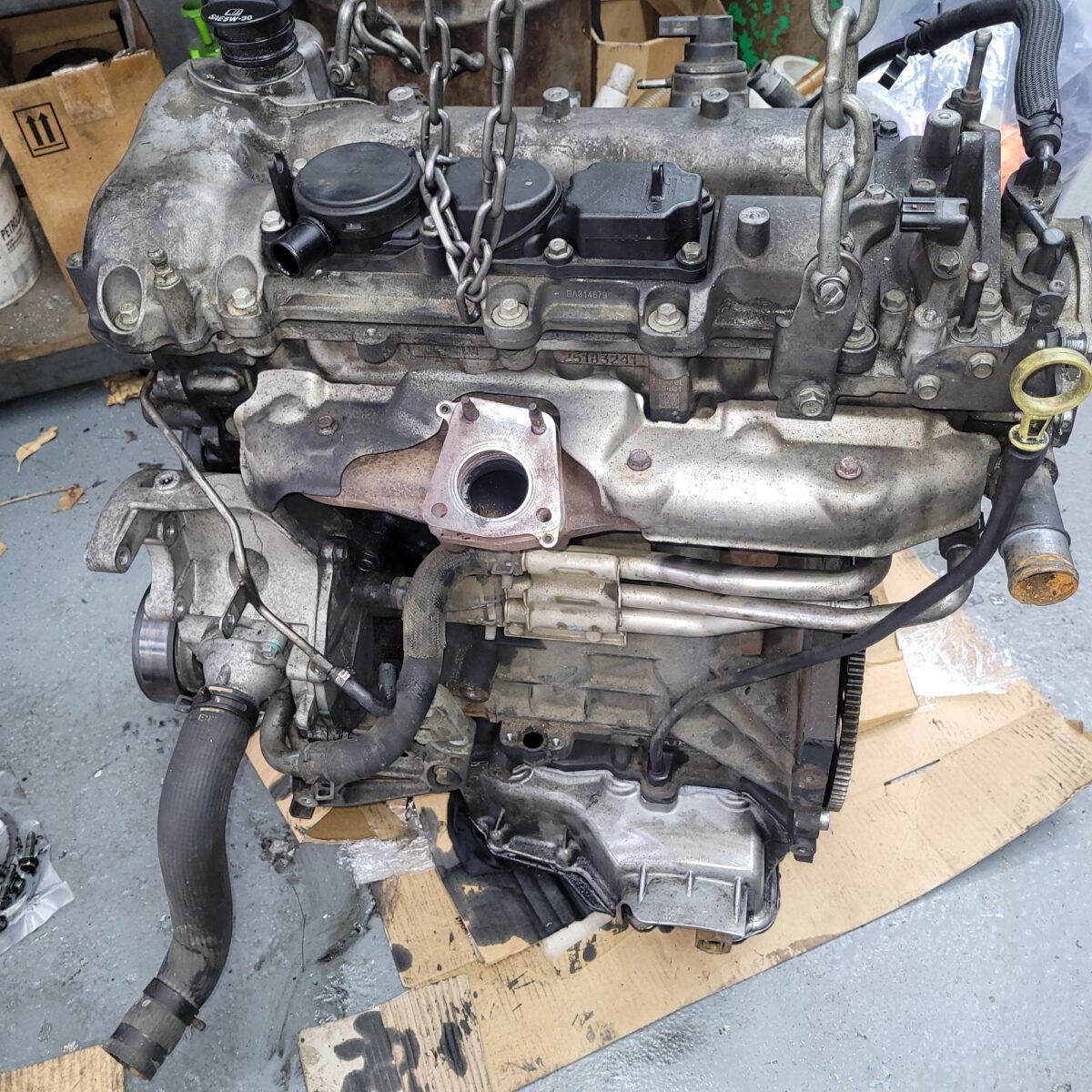 Car engine suspended by chains, showing components related to overheating prevention. Car engine suspended by chains, showing components related to overheating prevention.