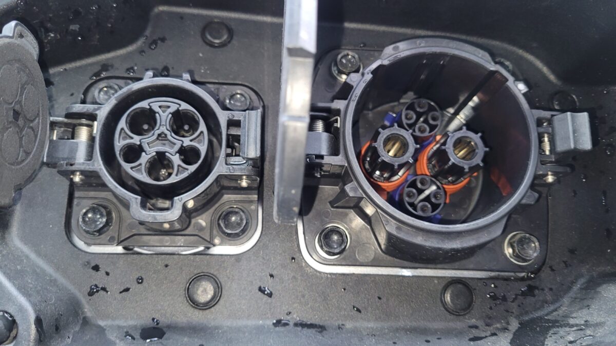 Close-up of an electric vehicle charging port with multiple connectors. Close-up of an electric vehicle charging port with multiple connectors.