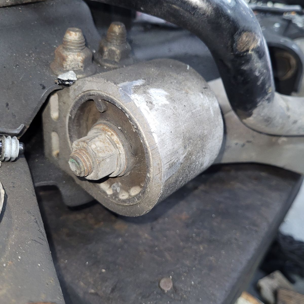 Close-up of a vehicle control arm bush Automotive control arm bush attached to suspension assembly