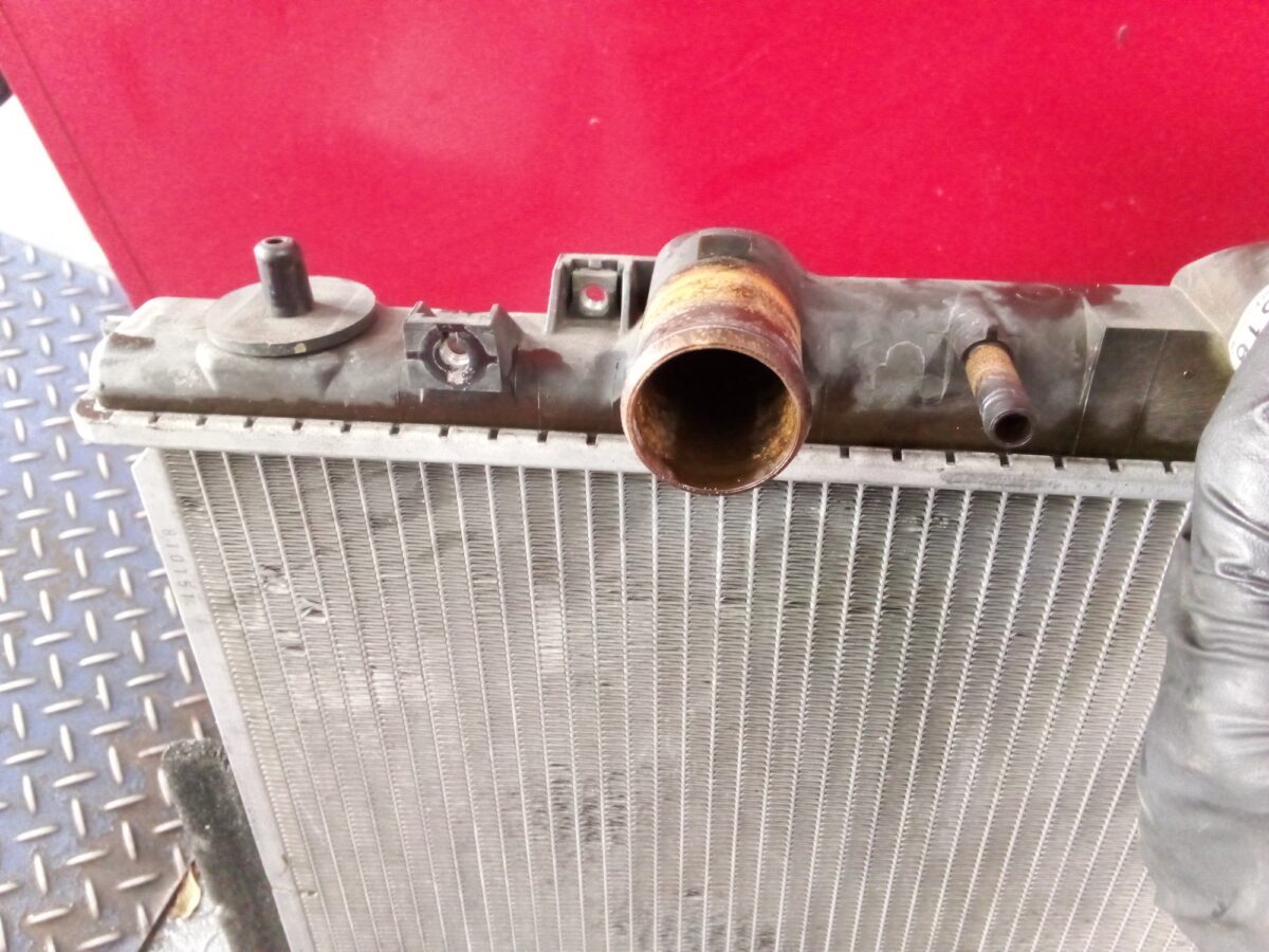 Close-up of a car radiator, showing the metal core and plastic top. Close-up of a car radiator, showing the metal core and plastic top.