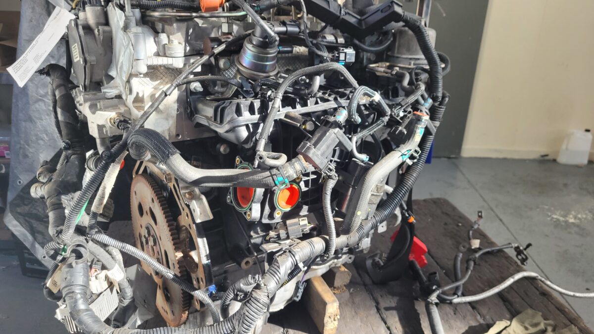 A detailed view of a complex car engine, with various wires and components. A detailed view of a complex car engine, with various wires and components.