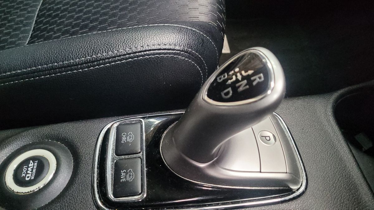 Automatic gear selector with R, N, D, B modes and control buttons in a car
