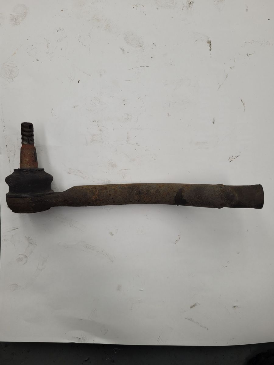 Rusty Automotive Tie Rod A worn and rusty tie rod for a vehicle steering system on a white background.