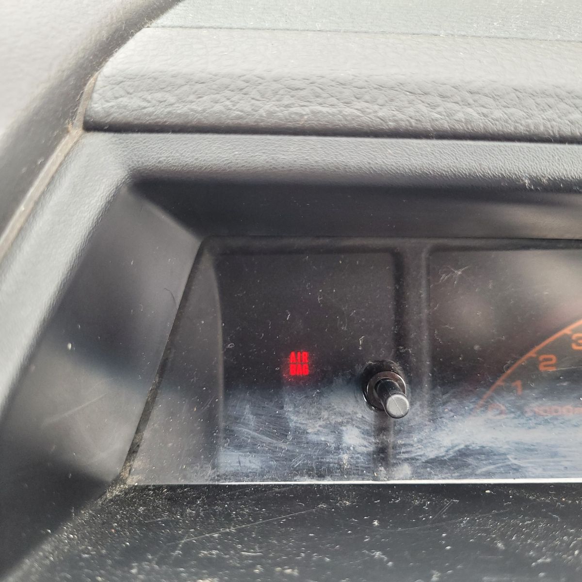 Dashboard Airbag Warning Light Illuminated Car dashboard with red airbag warning light illuminated