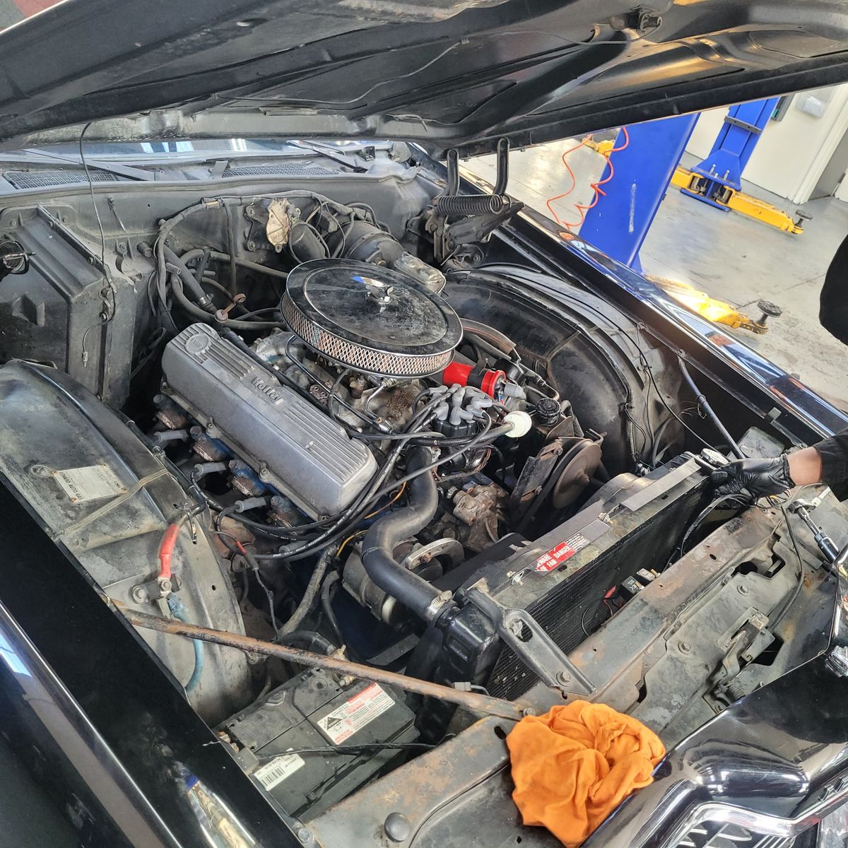 Classic Carburetted Engine in a Vintage Car Exposed view of a carburetted engine inside a classic car's open hood