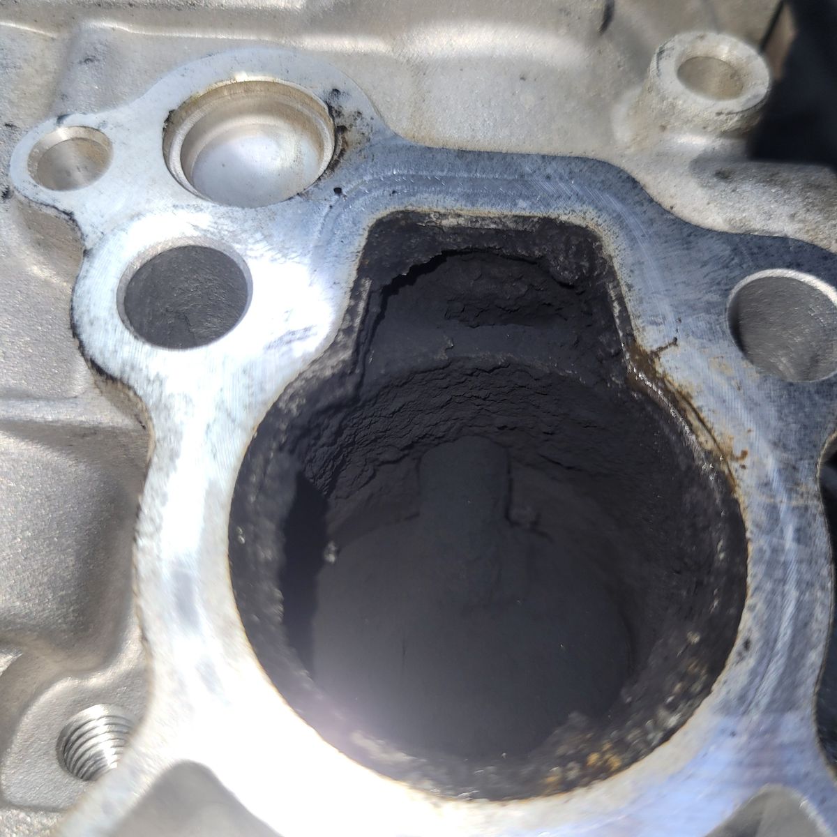 Dirty EGR System Close-Up Heavily carbon-clogged EGR passage in metal engine component