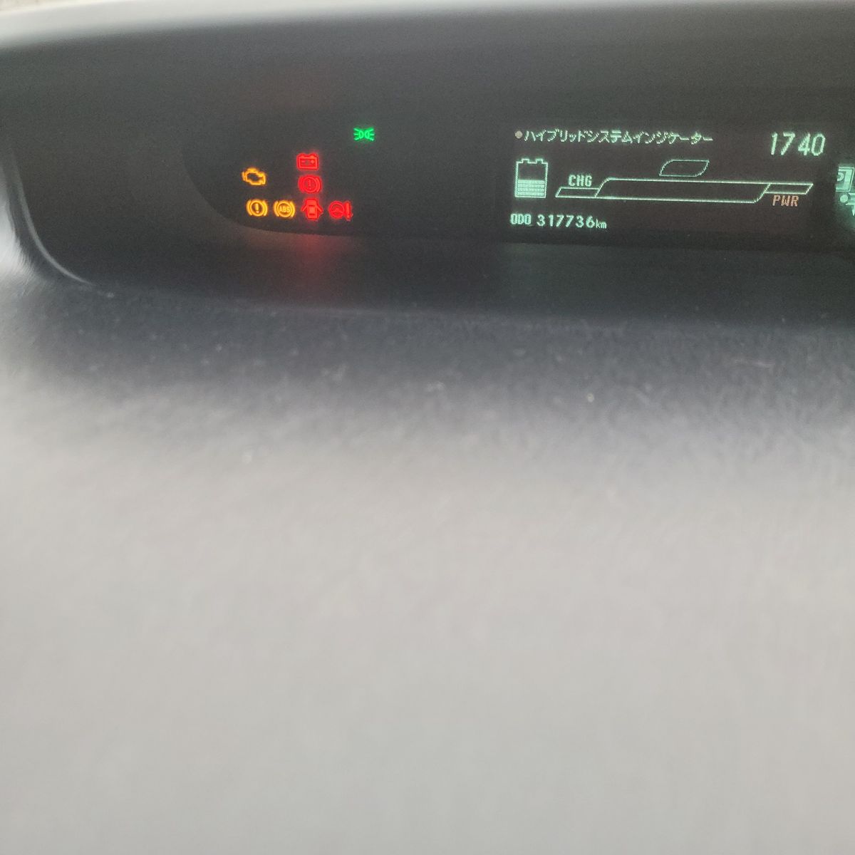 A car dashboard with various warning lights on in red and yellow