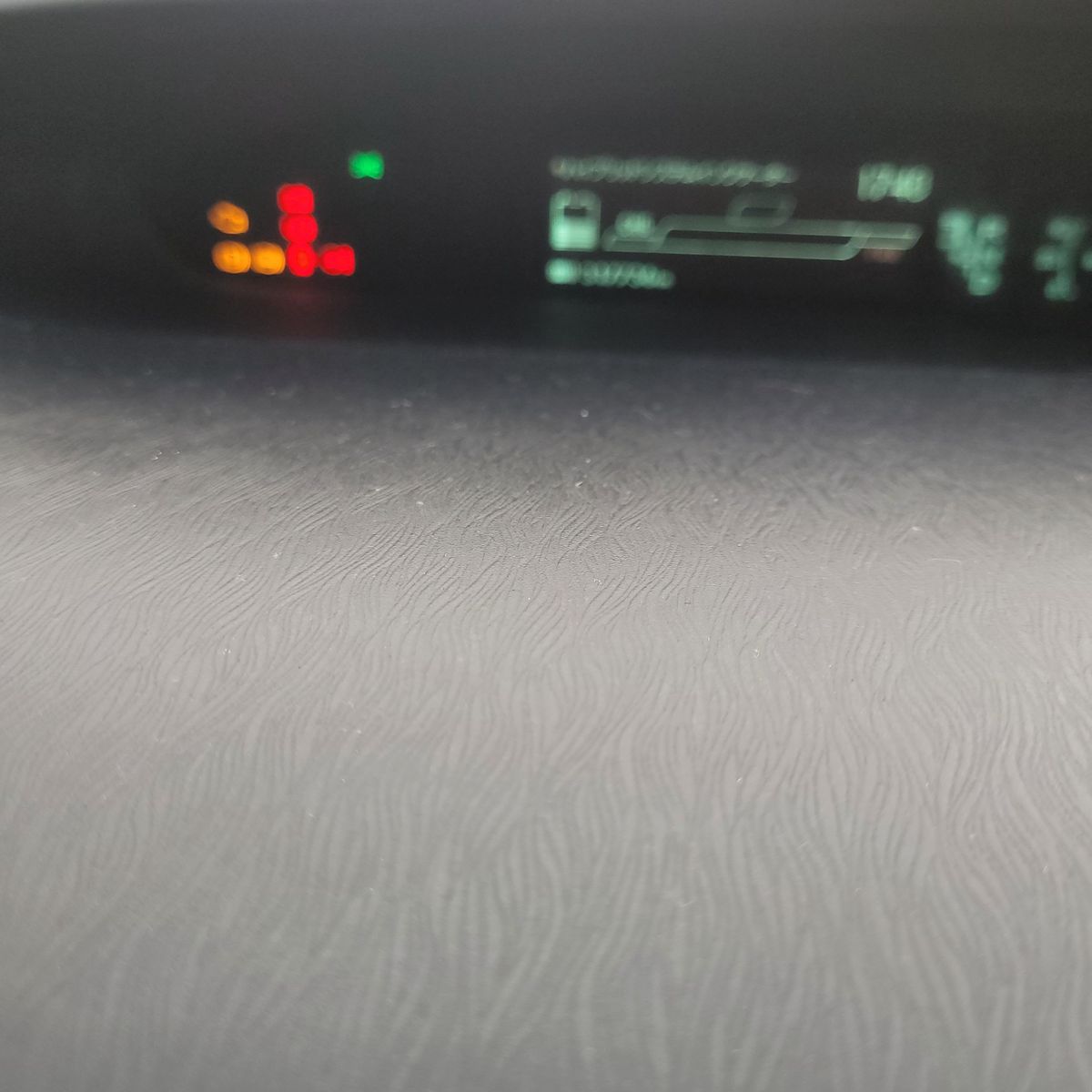 Blurry dashboard shows illuminated red and amber warning lights.