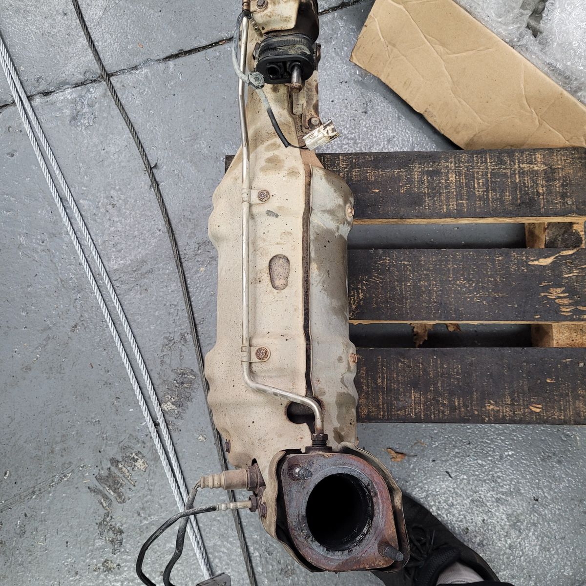 Worn diesel particulate filter with attached sensors on a pallet