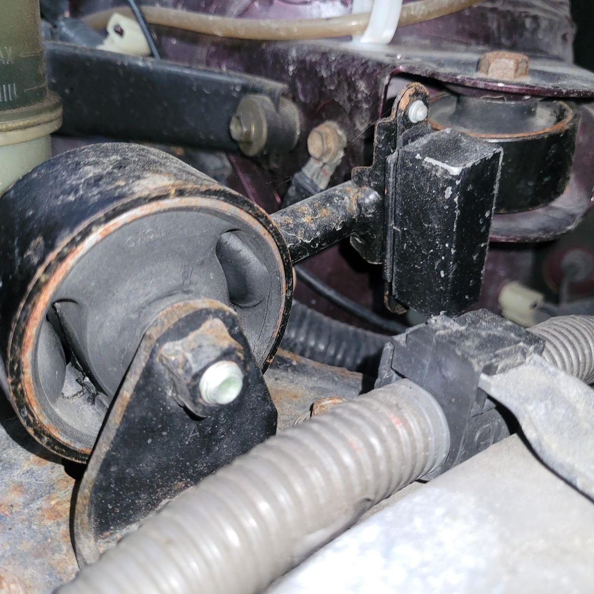 Close-Up of Car Engine Mount Engine mount with visible rubber bushing and rust on mounting hardware