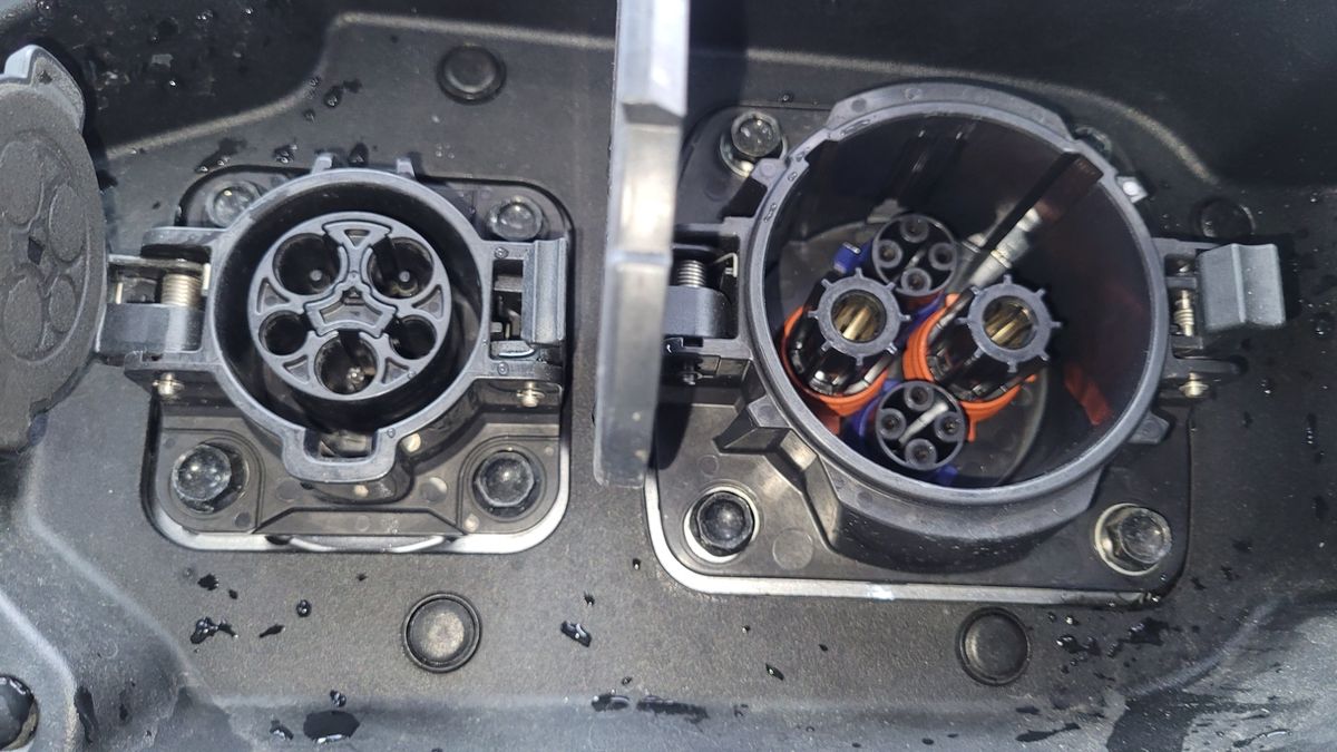 Close-up of two electric vehicle charging ports with open covers