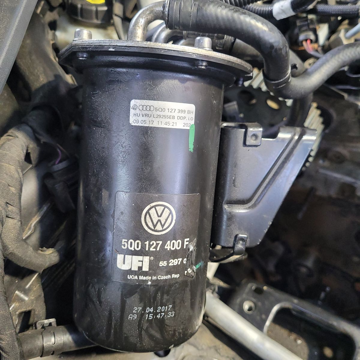 Volkswagen Diesel Fuel Filter Close-up Diesel fuel filter with Volkswagen logo and part number in car engine bay