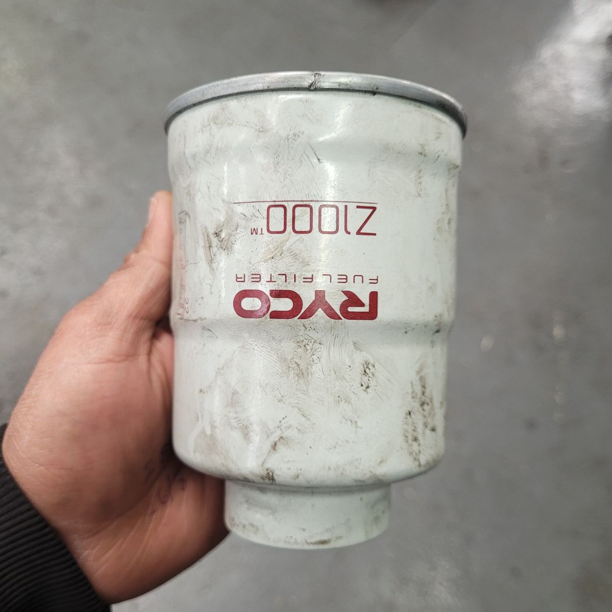 Person holding a dirty RYCO diesel fuel filter