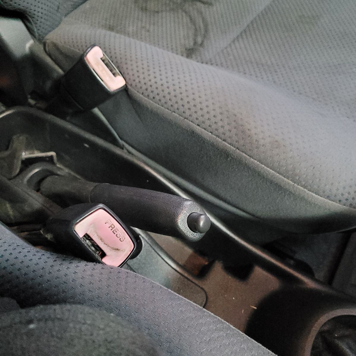 Handbrake in Raised Position Car handbrake lever pulled up between front seats