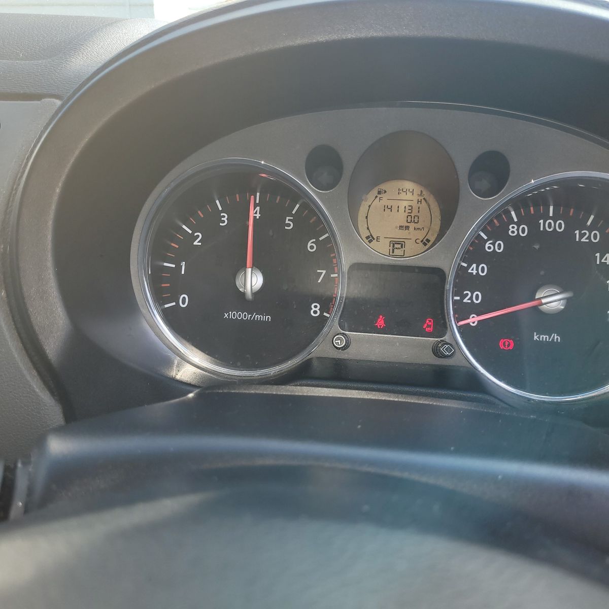 Car tachometer showing high RPM Car dashboard tachometer at 4000 RPM, speedometer at zero
