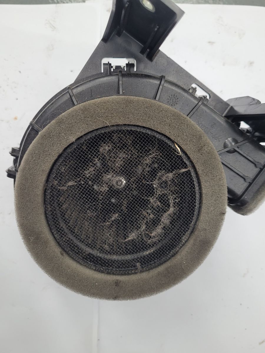 Dirty hybrid battery cooling fan covered in dust and debris