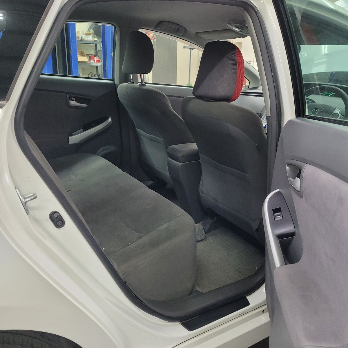 View of a hybrid car's back seat through an open rear door