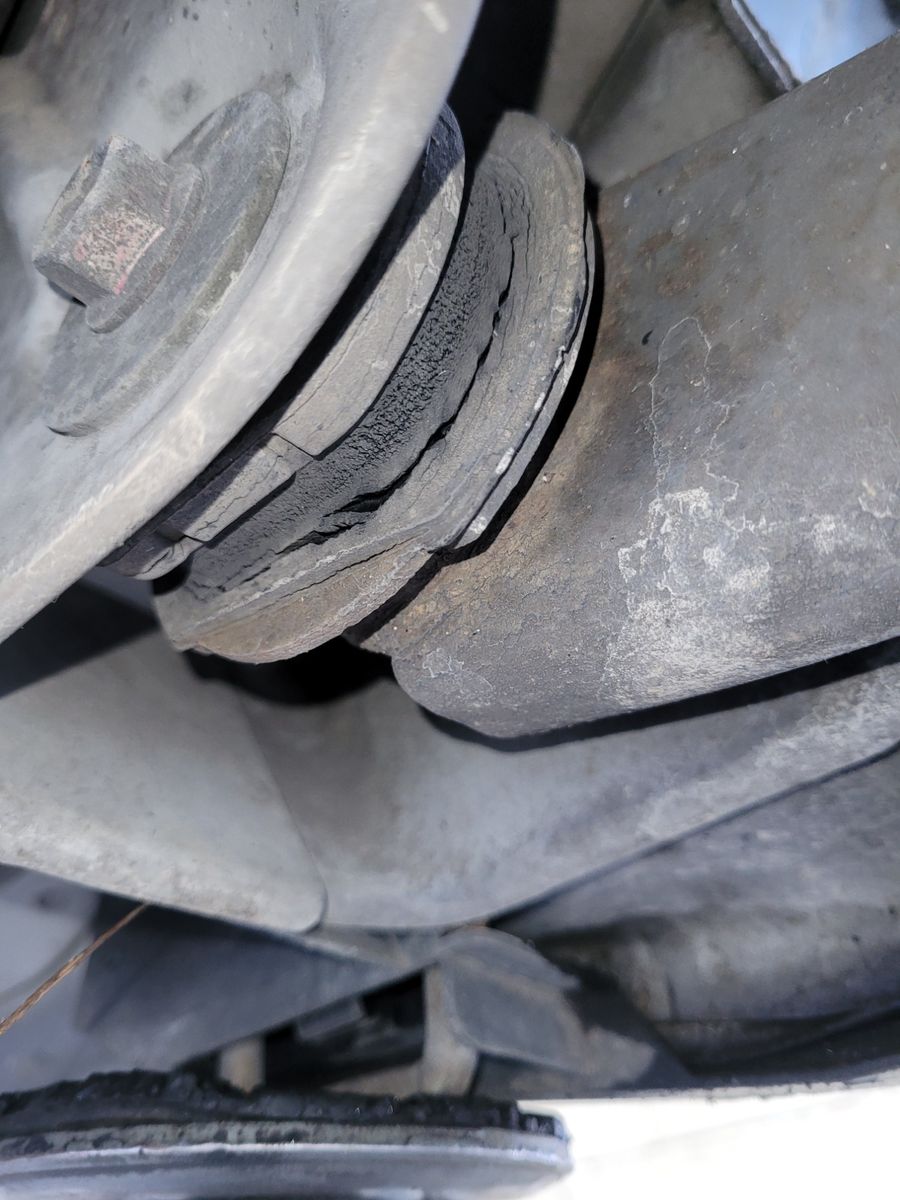 Close-up of a cracked bush on a bus lower control arm