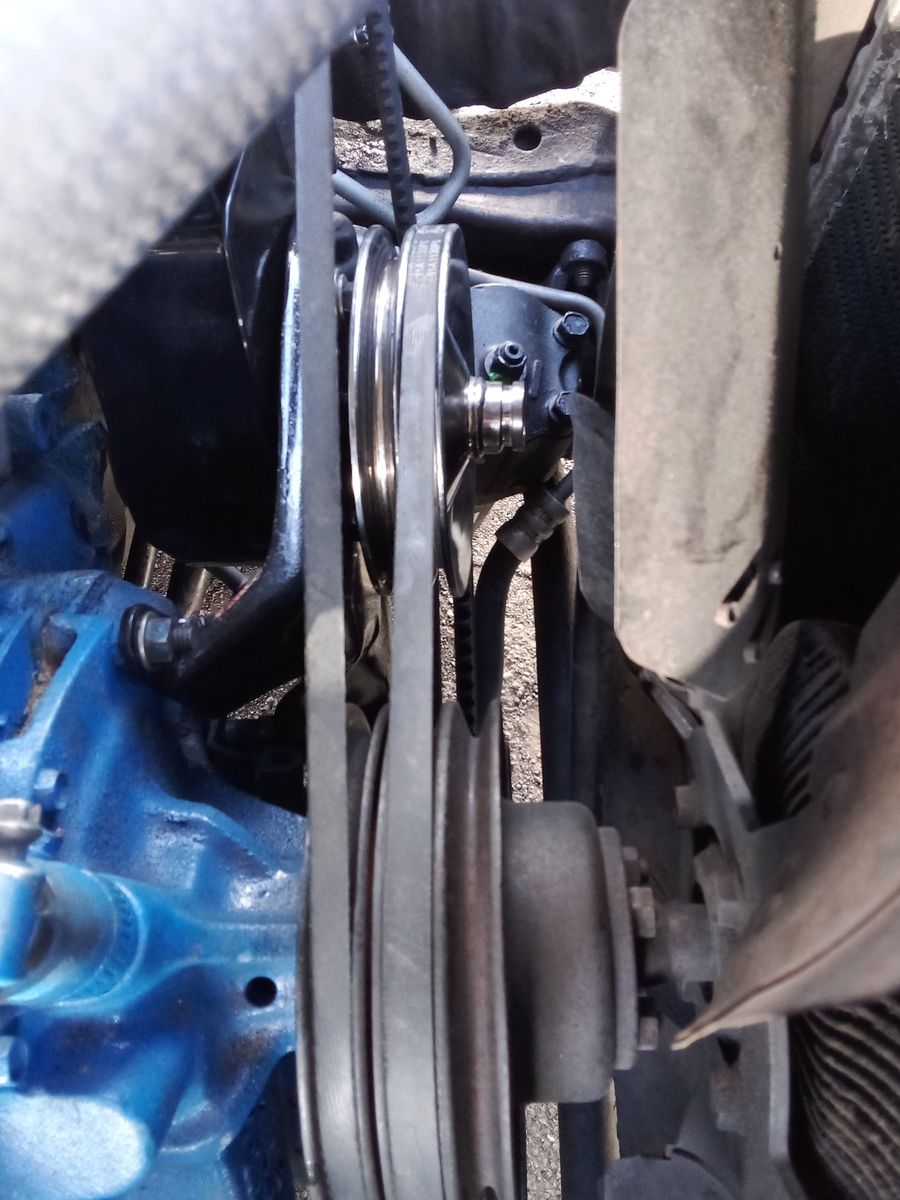Close-up View of Power Steering Belt on Engine Power steering belt connected to pulleys in a car engine compartment