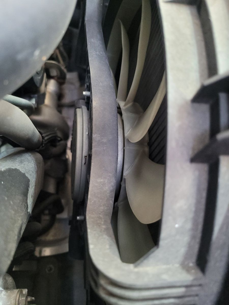 Close-up View of Car Radiator Fan Detailed shot of car radiator fan blades and surrounding components