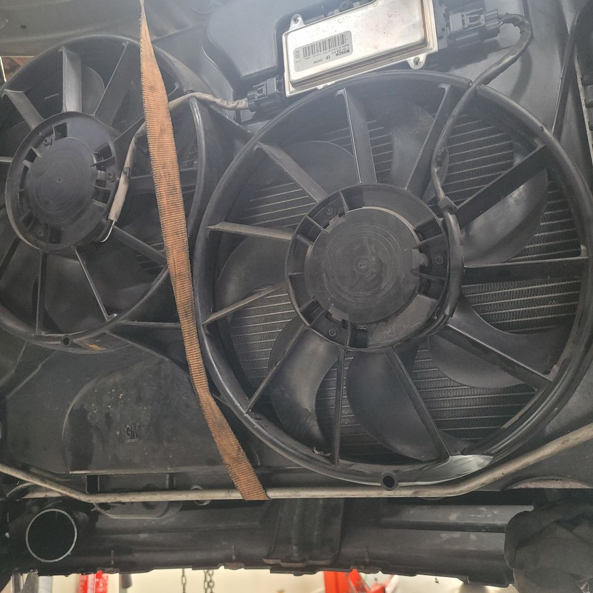 Close-up of Car Radiator Cooling Fans Two black radiator cooling fans mounted under a vehicle hood.