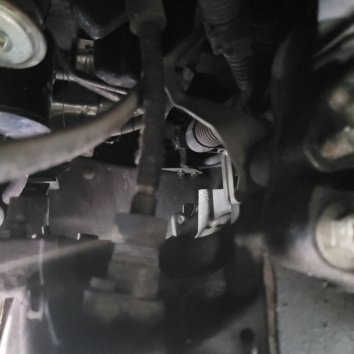 Close-Up View of Automotive Speedometer Cable Under-hood view of a speedometer cable among engine components