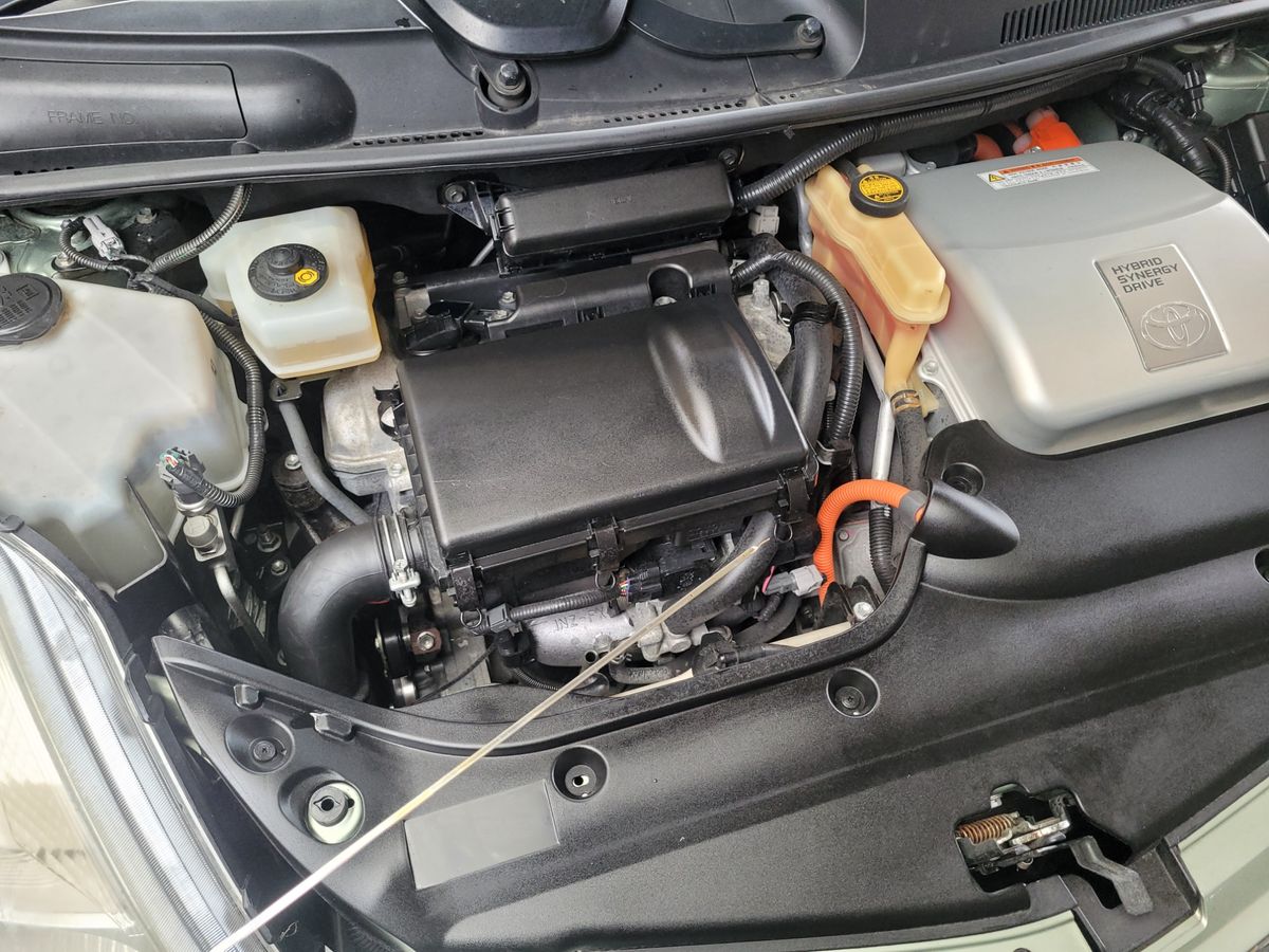 Toyota Hybrid Engine Bay Close-Up Engine bay of a Toyota hybrid vehicle showing Hybrid Synergy Drive components.