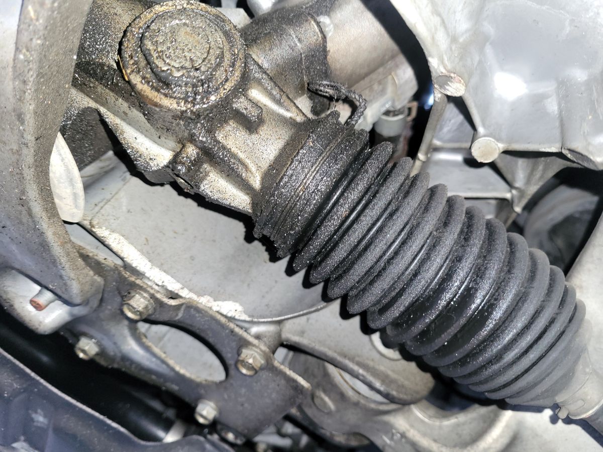 Close-up of Car Steering Rack Detailed view of a car's steering rack with a black rubber boot