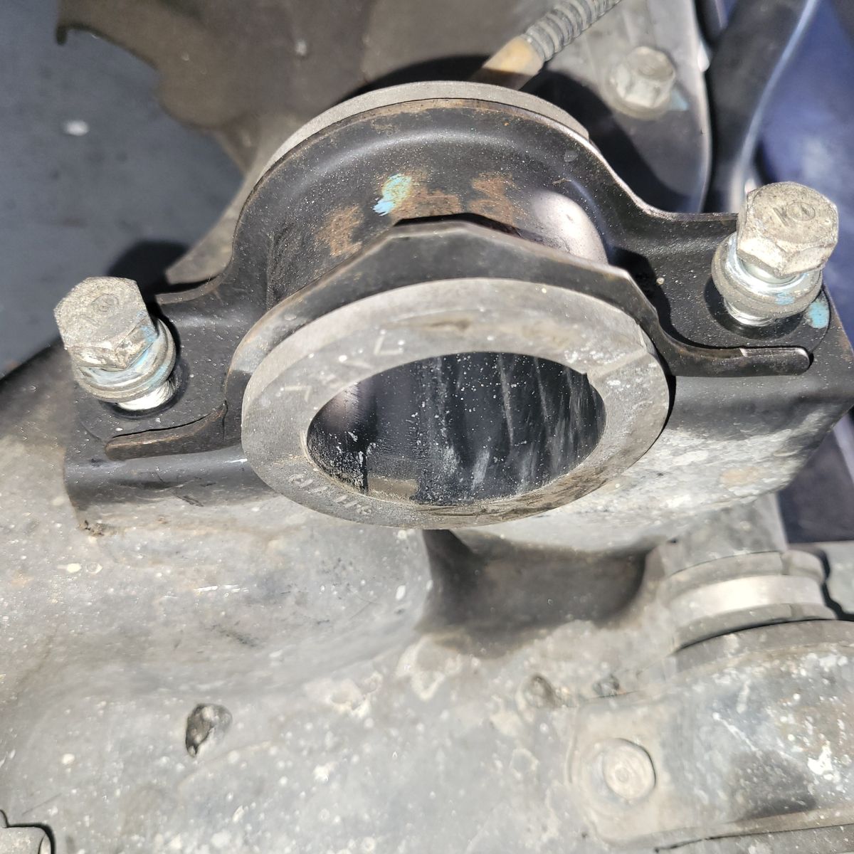 Close-up of Steering Rack Mount Bush Steering rack mount bush secured by two bolts on a car chassis