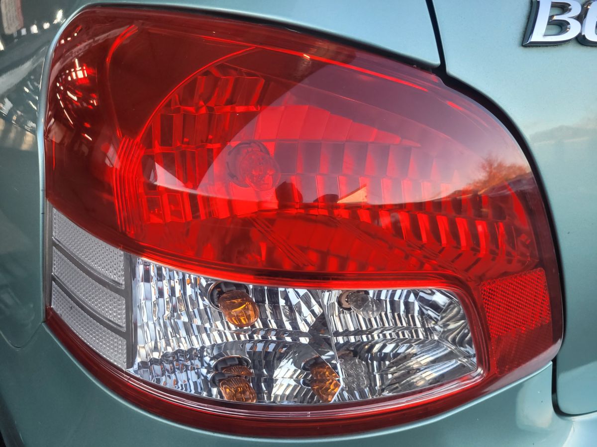 Close-up of a car's brake and tail light assembly.