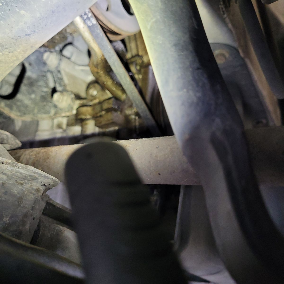 Oil Leak on Engine Timing Cover Close-up view of oil leaking from an engine timing cover area