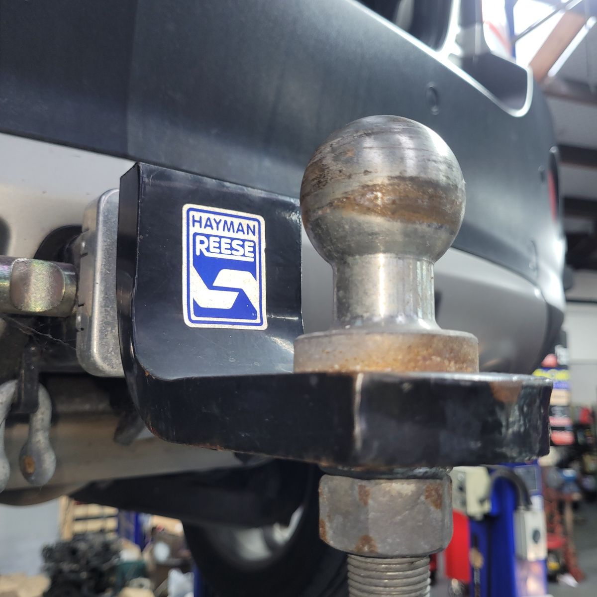 Hayman Reese Tow Bar Attached to Vehicle Close-up of a Hayman Reese tow bar hitch and ball on a car.
