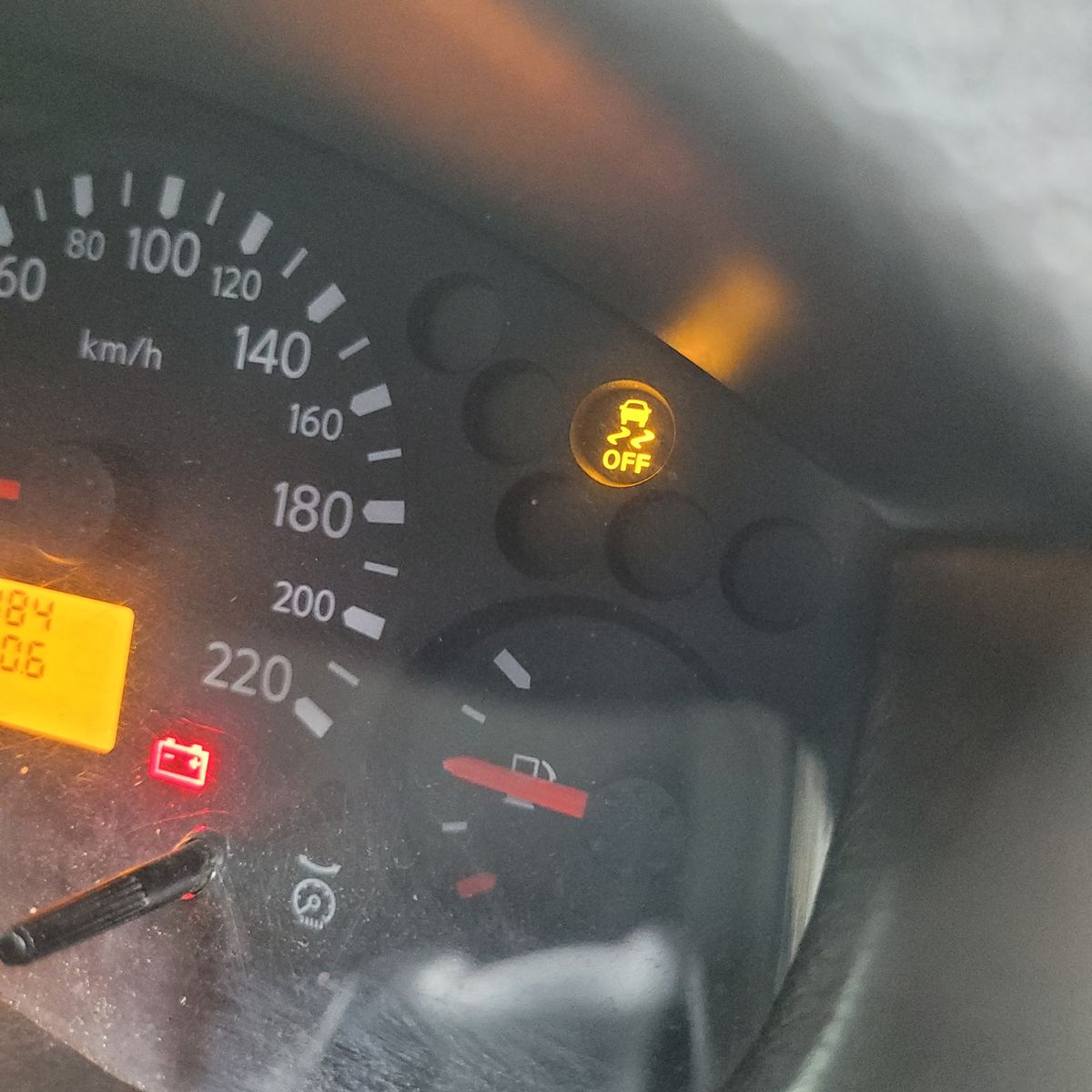 Dashboard with traction control off indicator illuminated in yellow.