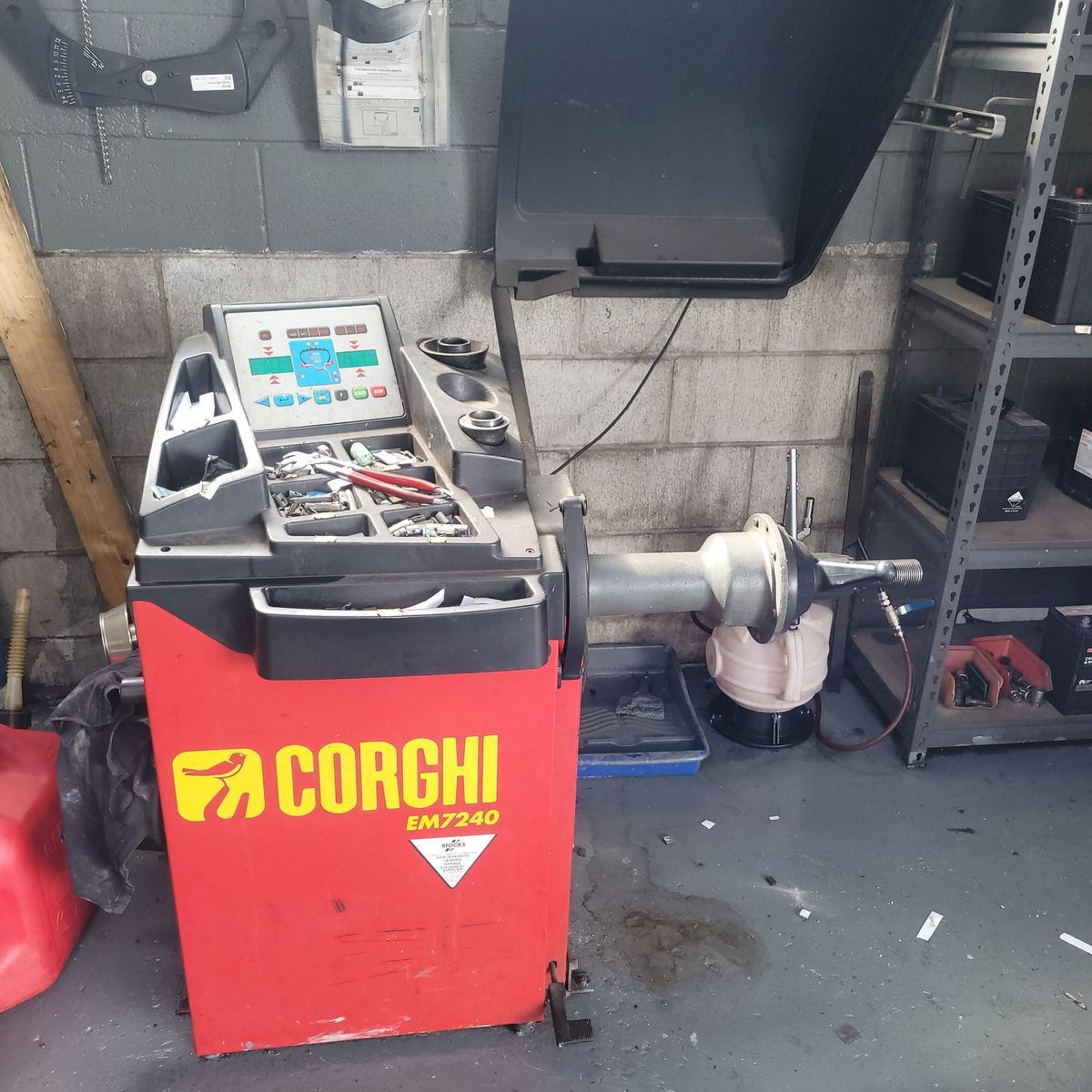 Corghi Tyre Balancing Machine in Workshop Corghi EM7240 tyre balancing machine with tools in a garage setting