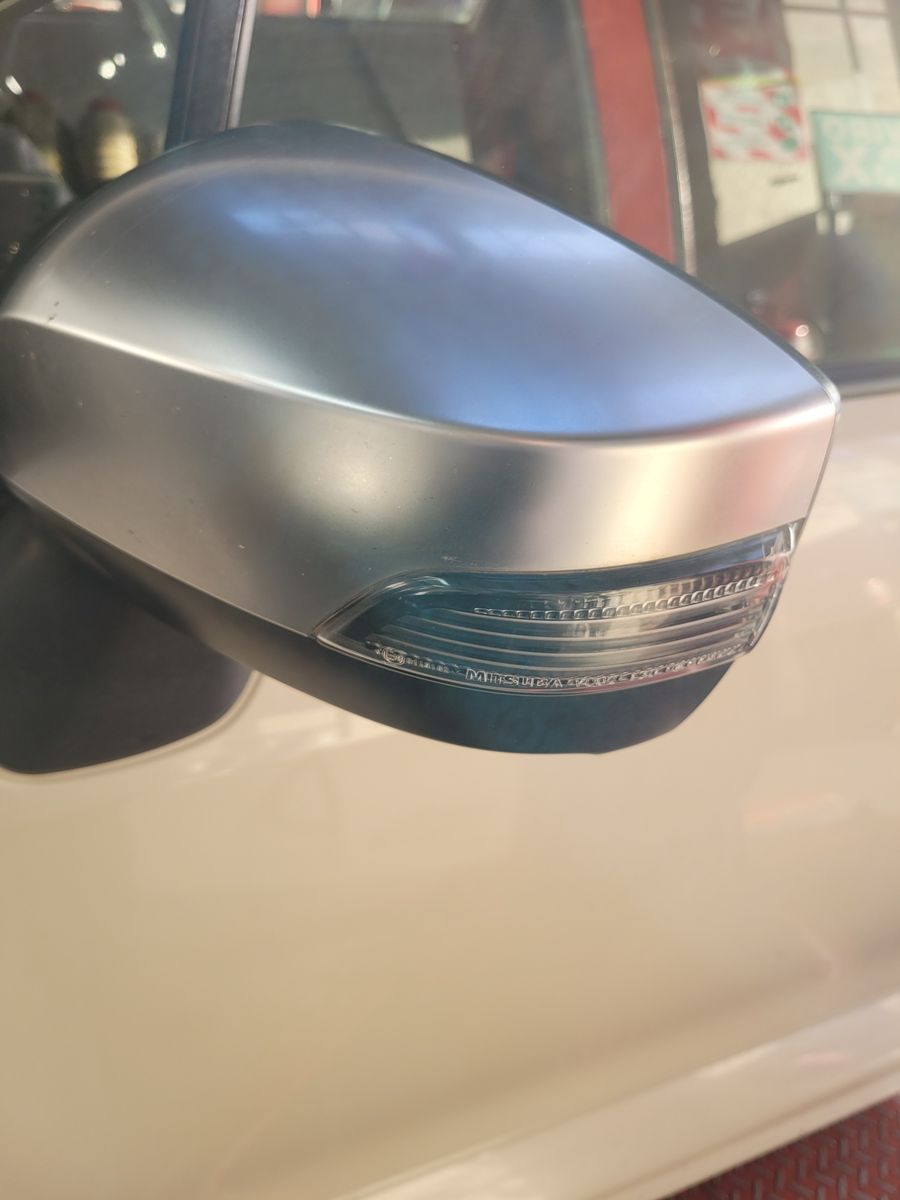 Silver car wing mirror with integrated turn signal light