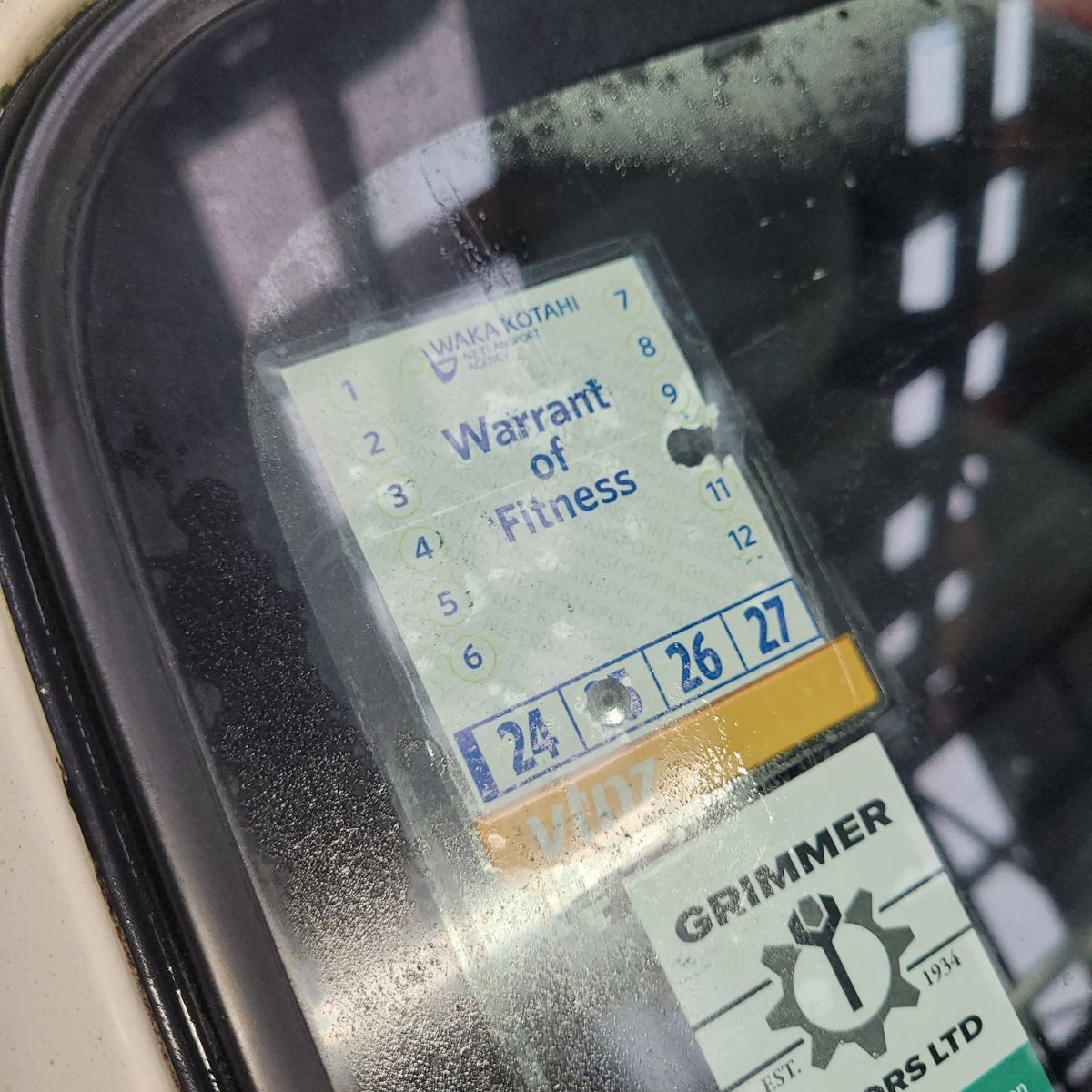 New Zealand Warrant of Fitness sticker on car windscreen Close-up of a Warrant of Fitness sticker displayed inside a car window