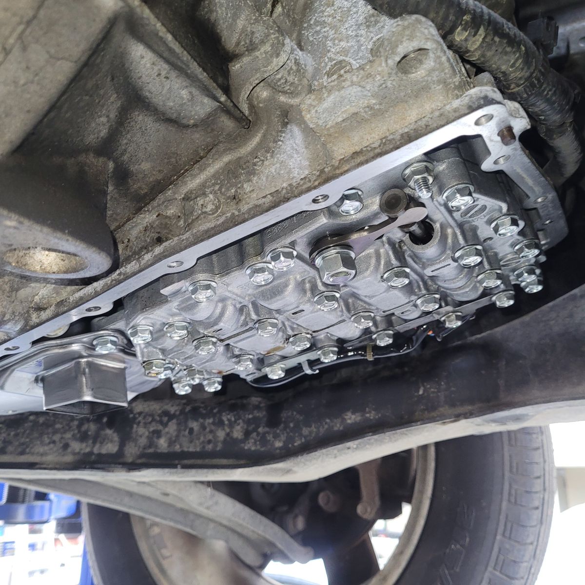 CVT Transmission Service Close-Up Detailed view of an exposed CVT transmission under a lifted vehicle