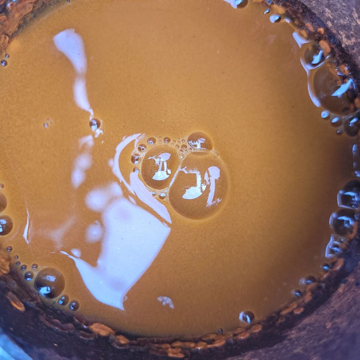 Murky brown water with rust and sediment from a radiator